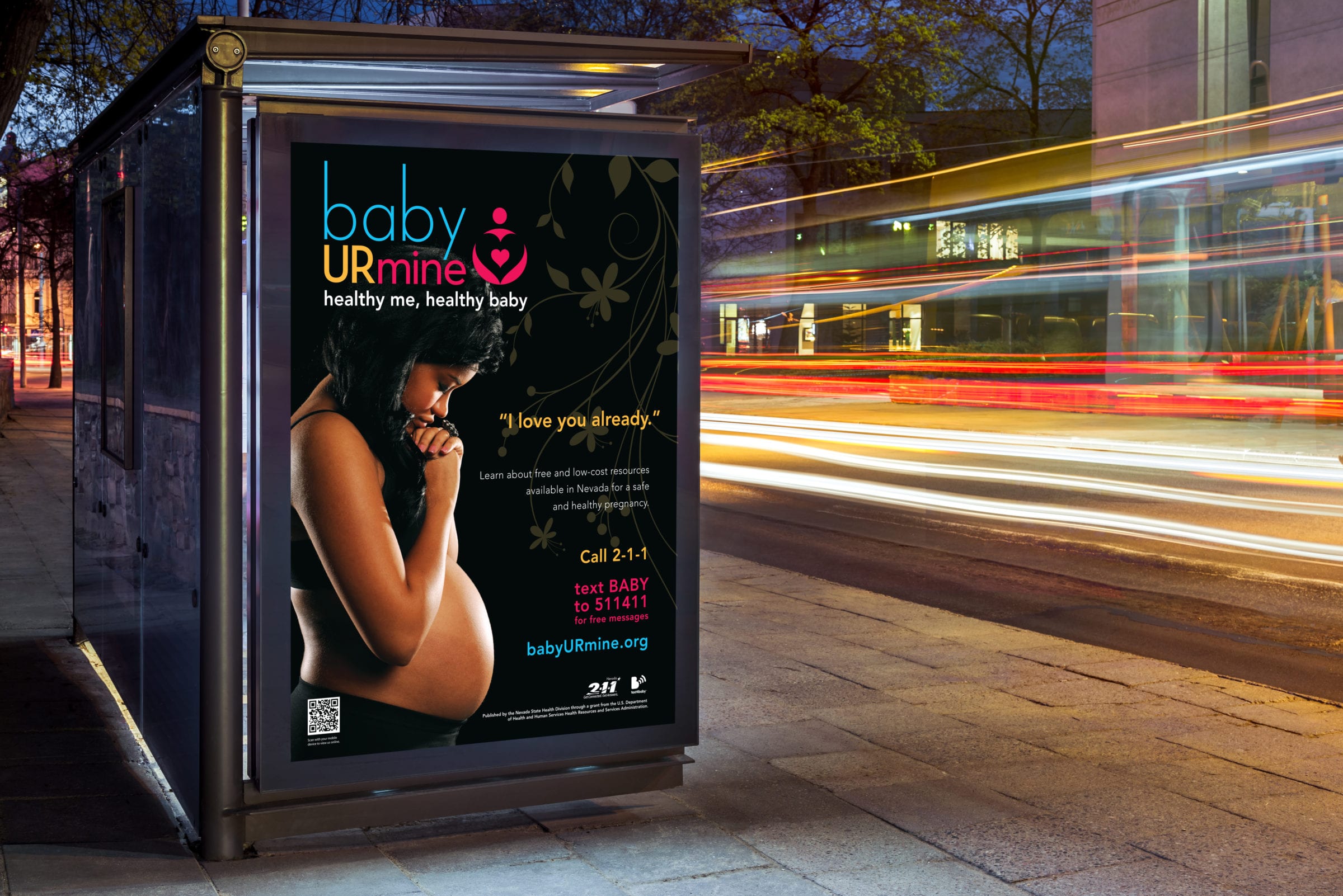 A bus-stop billboard with the "Baby Ur Mine" campaign, pictured with a pregnant woman.
